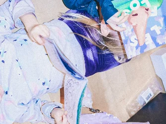 A teacher interacting with students at their level by sitting on the floor and teaching them directly. This image highlights personalized learning, student engagement, and the importance of creating a comfortable, collaborative classroom environment that encourages participation and understanding.